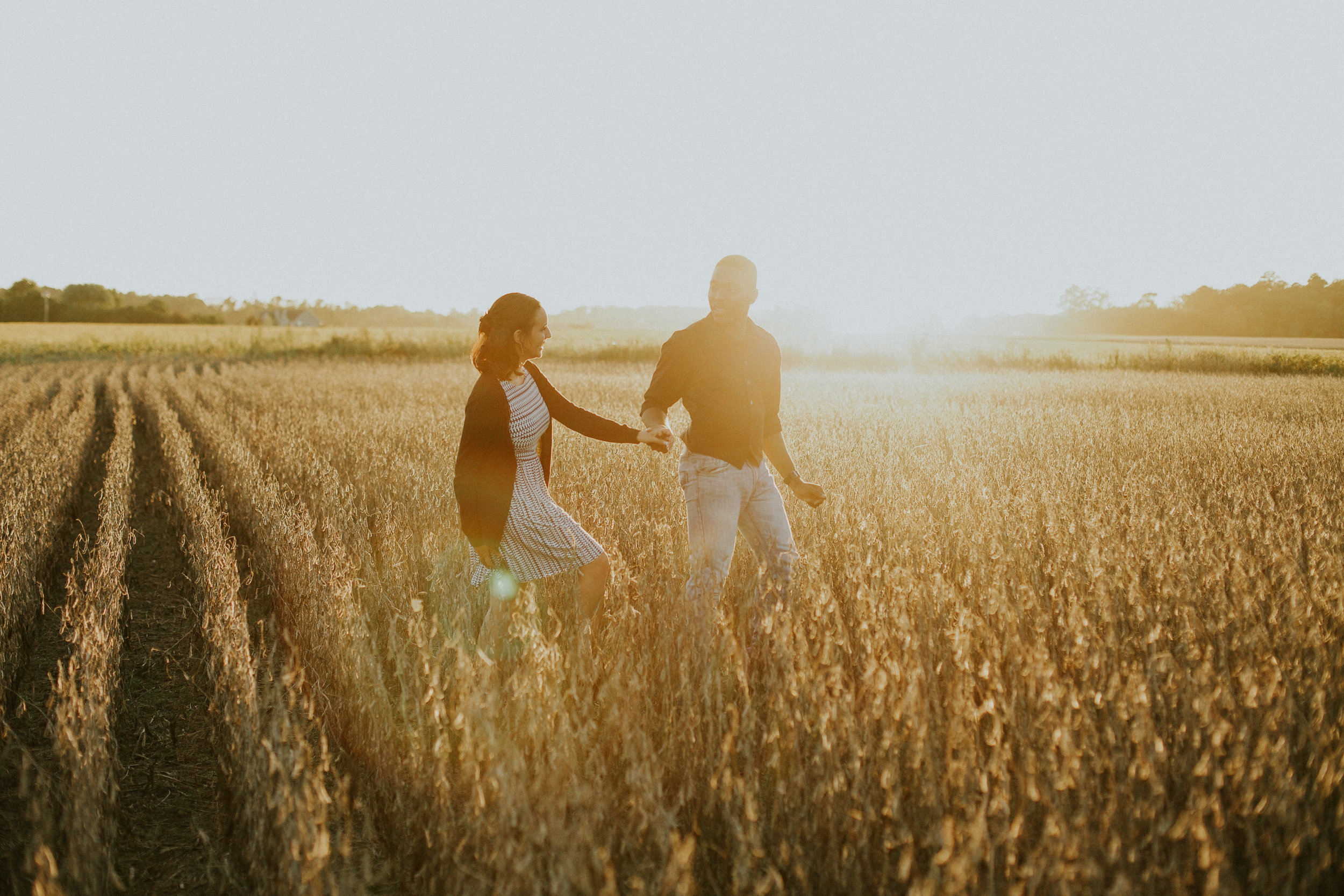 Delaware-Photographer walking during golden hour in a field