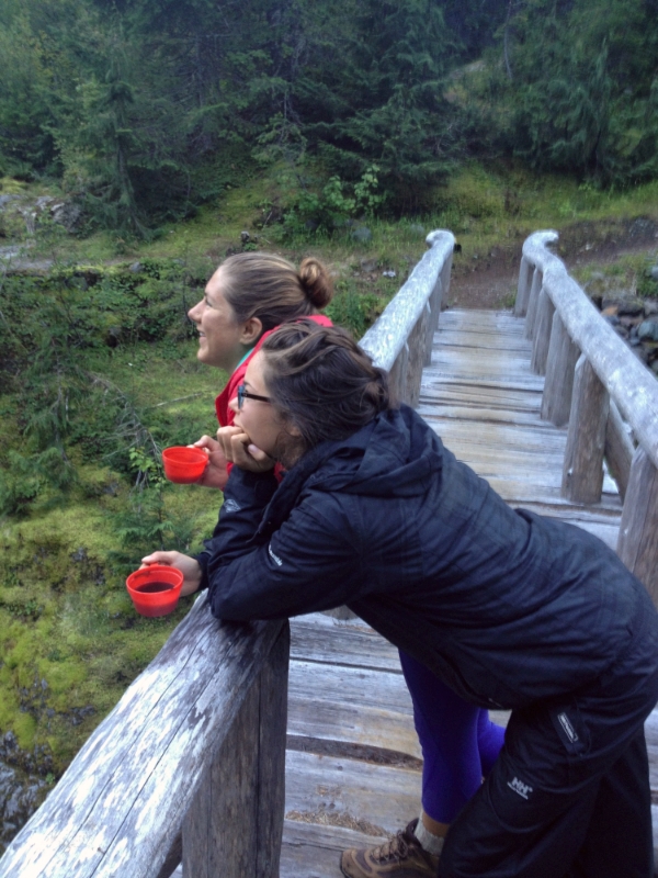 My friend Jenna and I taking a moment to enjoy the sunrise and river with our coffee while hiking the Wonderland Trail around the base of Mt. Rainier.