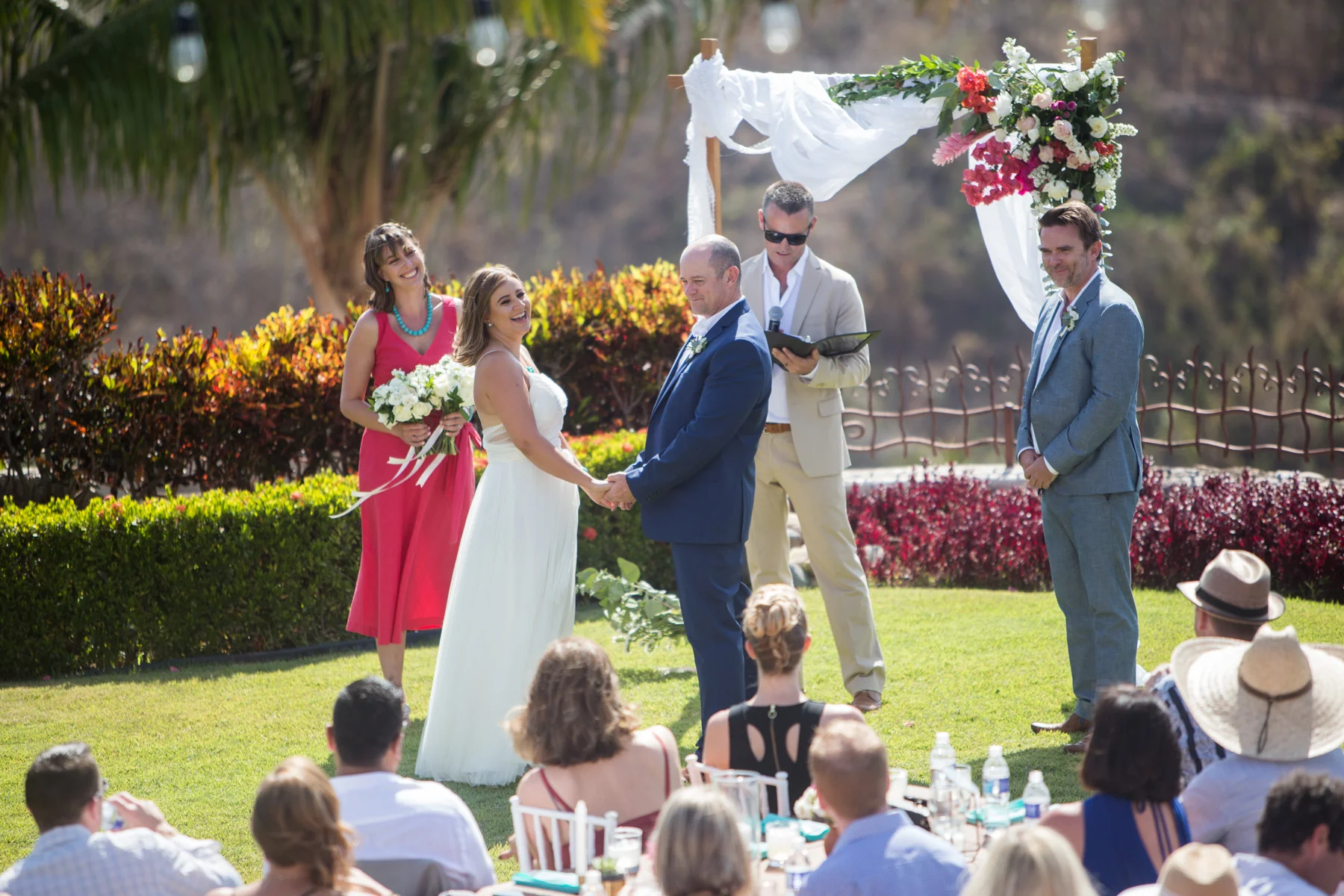 Sayulita wedding photographer Erin Parker captures Tara and Bryan laughing during their ceremony at Hacienda Antigua. Their Hacienda Antigua wedding was in Lo de Marcos, Mexico