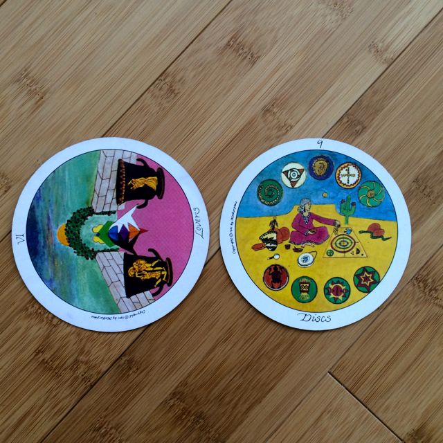 Lovers to the left and Nine of Pentacles, Motherpeace deck