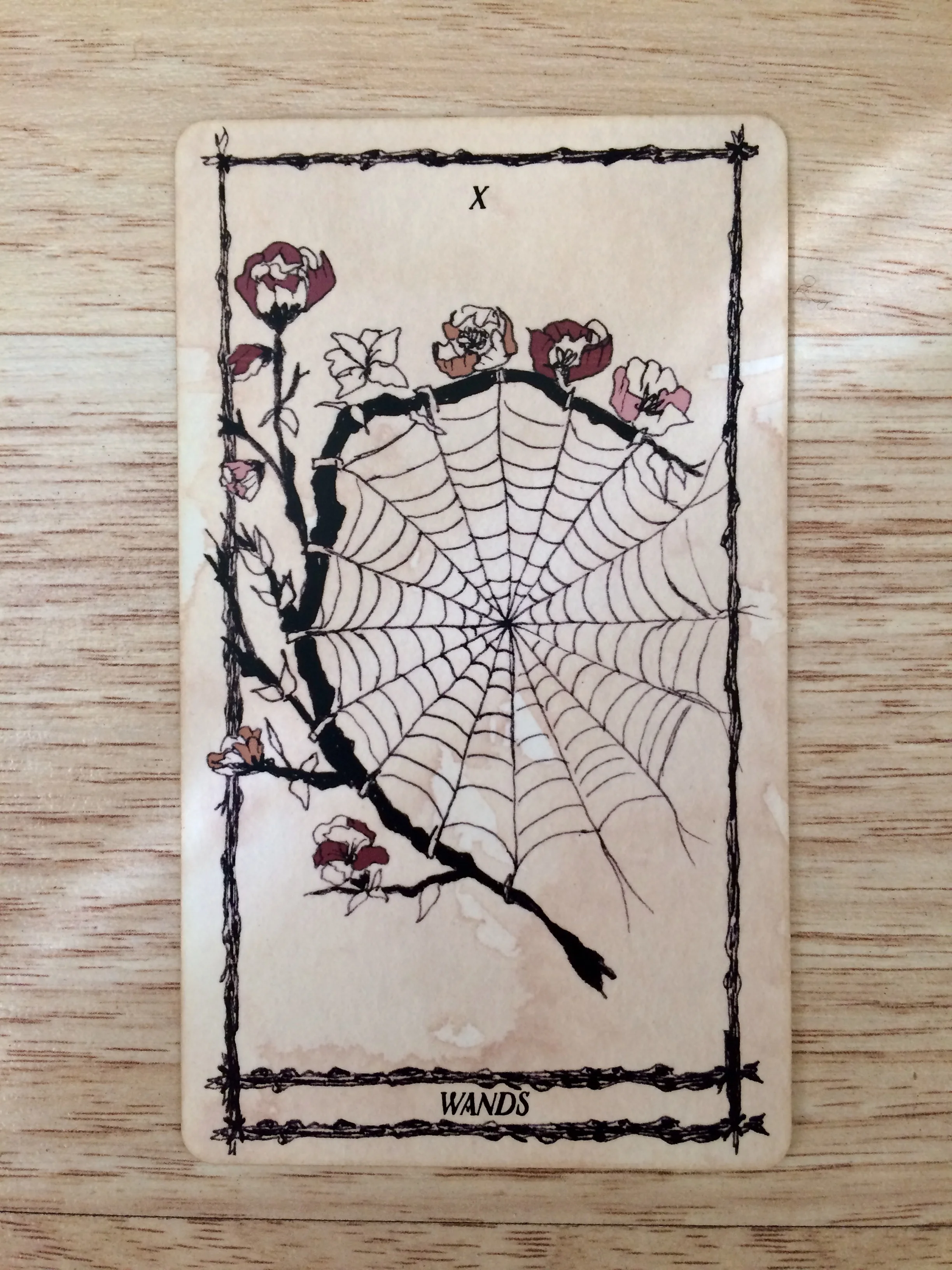 Ten of Wands from Ophidia Rosa Tarot