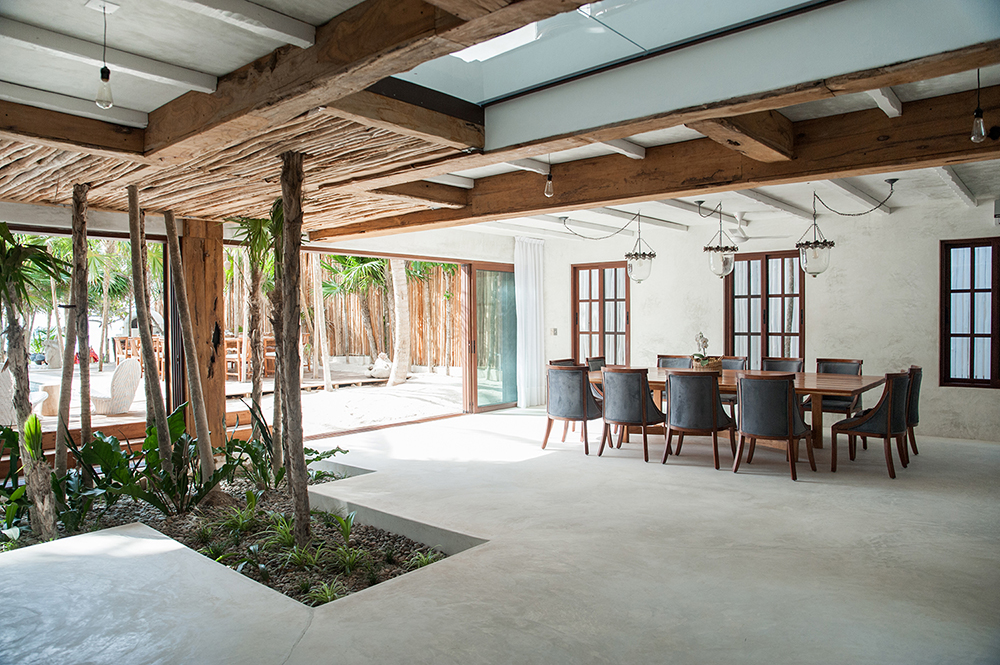 The open living/dining plan allows for unobstructed views of the turquoise waters of Soliman Bay.