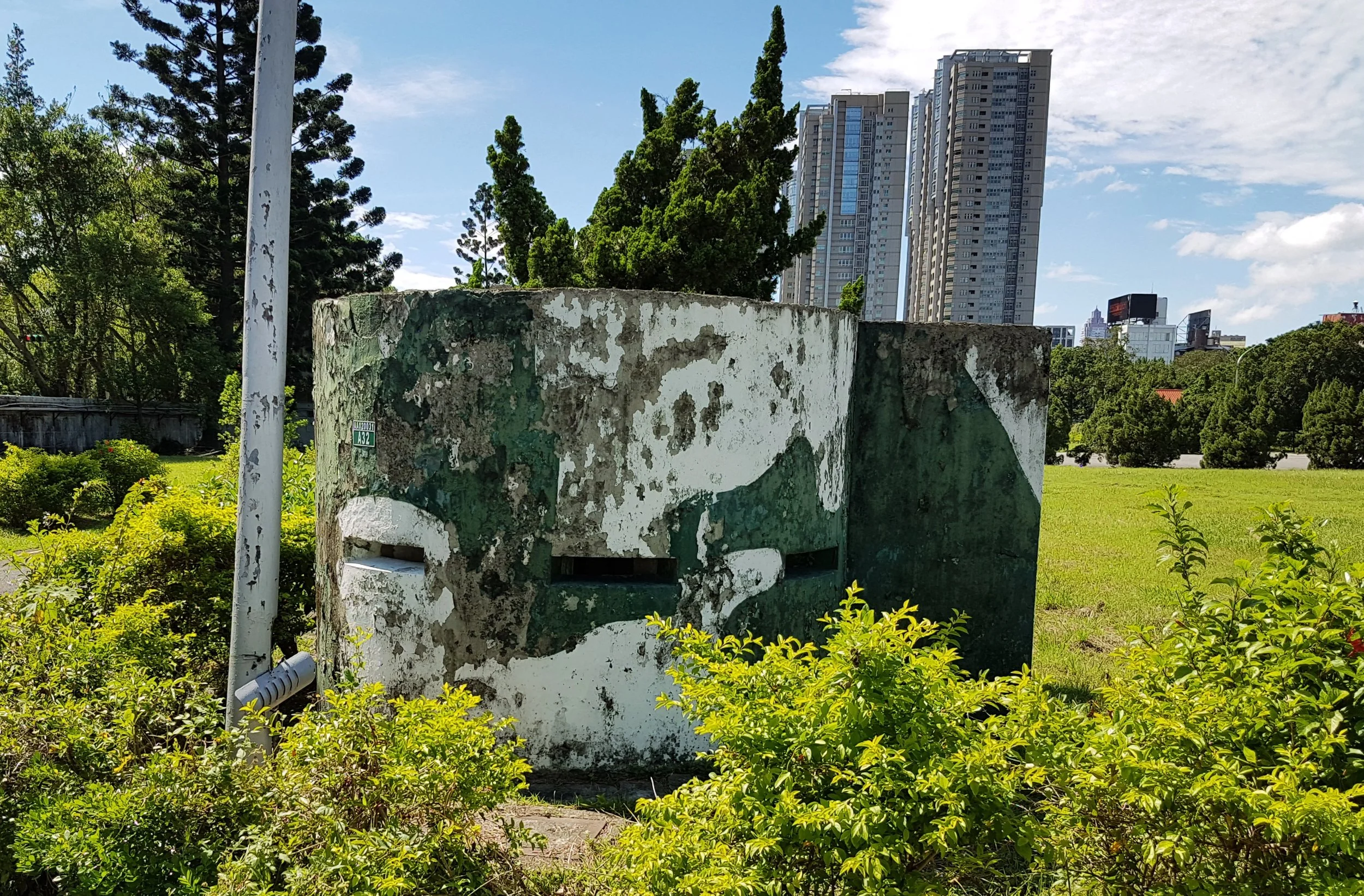 A pillbox with the Palace complex behind it.