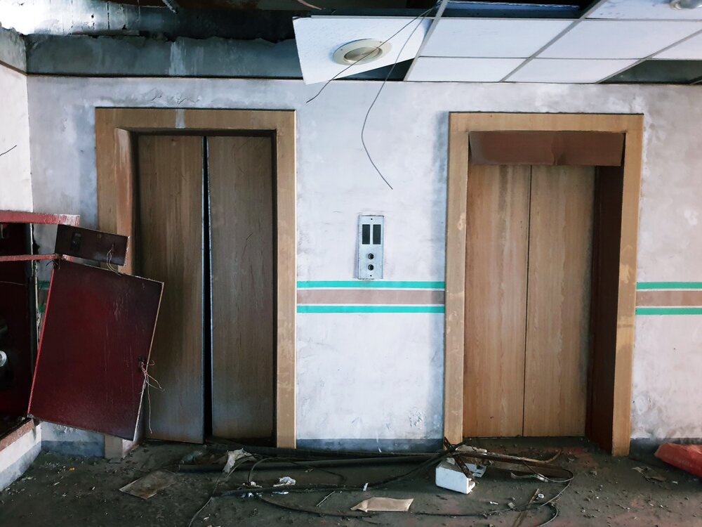 Arcade machines and broken elevators. On the left is the similarly abandoned Golden Horse Tower in Yuanlin