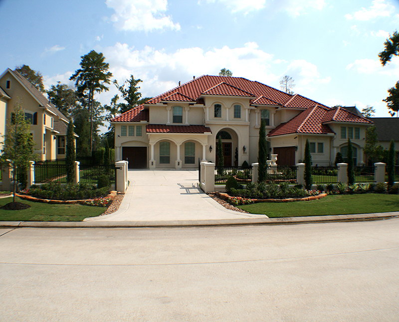 formal-planting-with-italian-cypress-roses-boxwood,-seasonal-color,-moss-rock-retaining-walls-and-bullrock-banding,-The-Woodlands-Texas.jpg