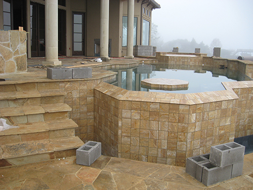 pool-design-construction-beautiful-zero-edge-infinity-lake-view-slope-water-pebble-tec-pool-builder-installation-patio-stairway-best-builder-company-envy-exteriors-the-woodlands-houston-spring-magnolia-conroe-montgomery-cypress-aggie.jpg