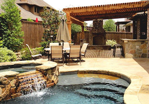 outdoor-arbor-pergola-fireplace-patio-pool-flagstone-custom-design-build-pool-builder-waterfall-covered-deck-decking-landscaper-company-pools-the-woodlands-magnolia-houston-cypress-montgomery-conroe-tomball.jpg