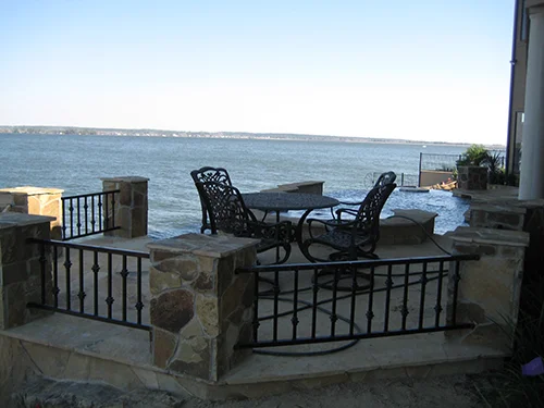 outdoor-seating-area-pool-lake-conroe-lake-conroe-stone-flagstone-landscape-pool-design-pool-builder-new-retention-walls-on-lake-best-installation-custom-design-the-woodlands-houston-spring-magnolia-conroe-montgomery-cypress.jpg