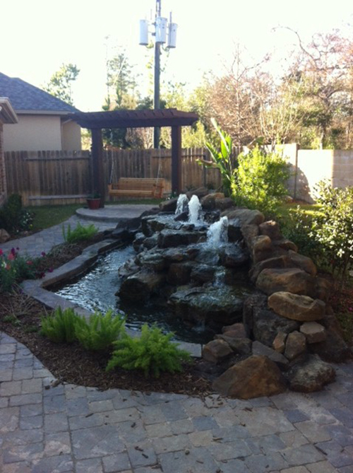 waterfall-custom-built-moss-rock-stone-rock-outdoor-large-fountain-design-install-repair-company-builds-builder-home-best-installers-patio-on-woodforest-the-woodlands-houston-spring-magnolia-conroe-montgomery-cypress-natural-pool.jpg