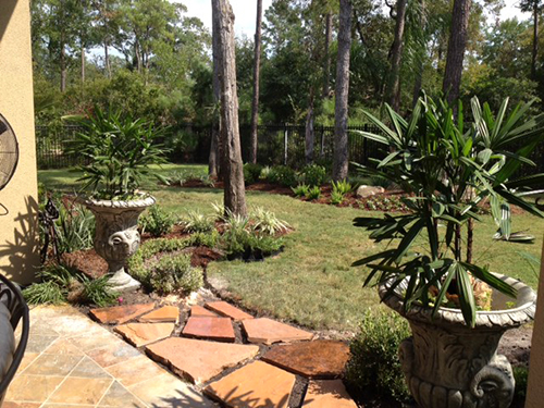 flagstone-planters-palms-landscape-installation-the-woodlands-back-patio-envy-exteriros.jpg