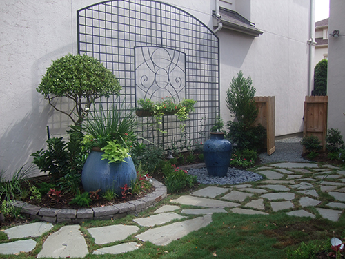glazed-pot-pottery-urn-patio-trllis-wrought-iron-vines-landscape-flagstone-path-landscape-install-installation-best-design-designer-the-woodlands-top-spring-woodforest-montgomery-conroe-spring-cypress-build-builder-aggie-owned.jpg