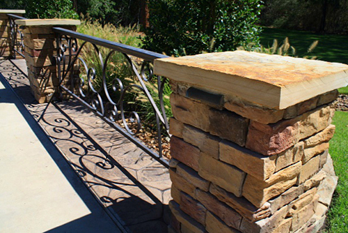 stone-columns-coranado-caramel-mountain-manufactured-stone-with-wrought-iron-scroll-flagstone-cap-the-woodlands-envy-spring.jpg
