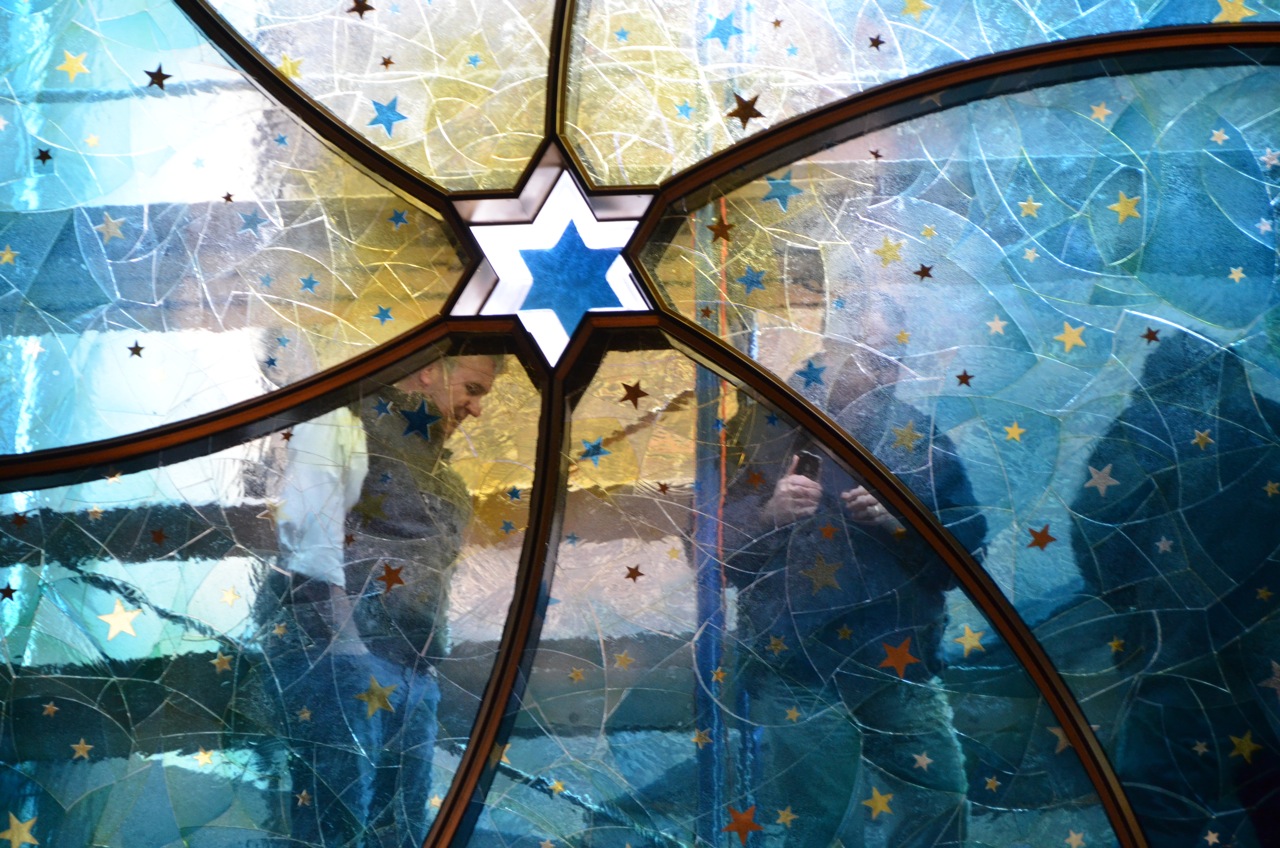 In both the existing synagogue and the window, the six pointed star is reserved for the center. In the window, this star is a single piece of cast glass that extends upwards and out of the bronze frame. 