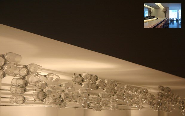Above the bar, Gans also fused together a series of champagne flutes with airplane window glue and fishing line. Hence, the name "flight"