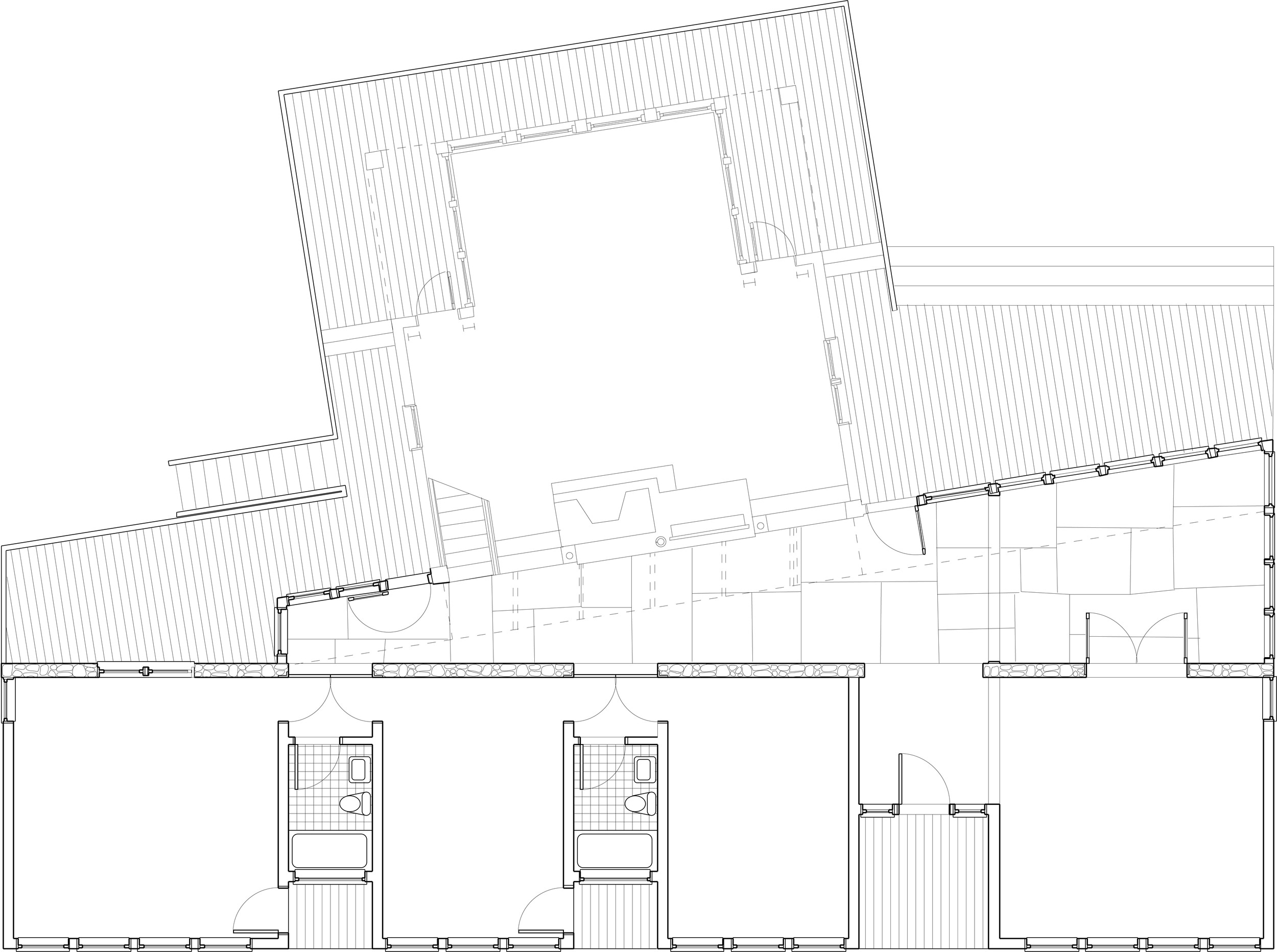 The front of the house is a low bar of bedroom/bath suites with outdoor showers to the left of a recessed foyer and a kitchen to the right. This bar is a threshold to a tall volume rotated to the ocean view with living and dining room below and a children's dormitory above. 