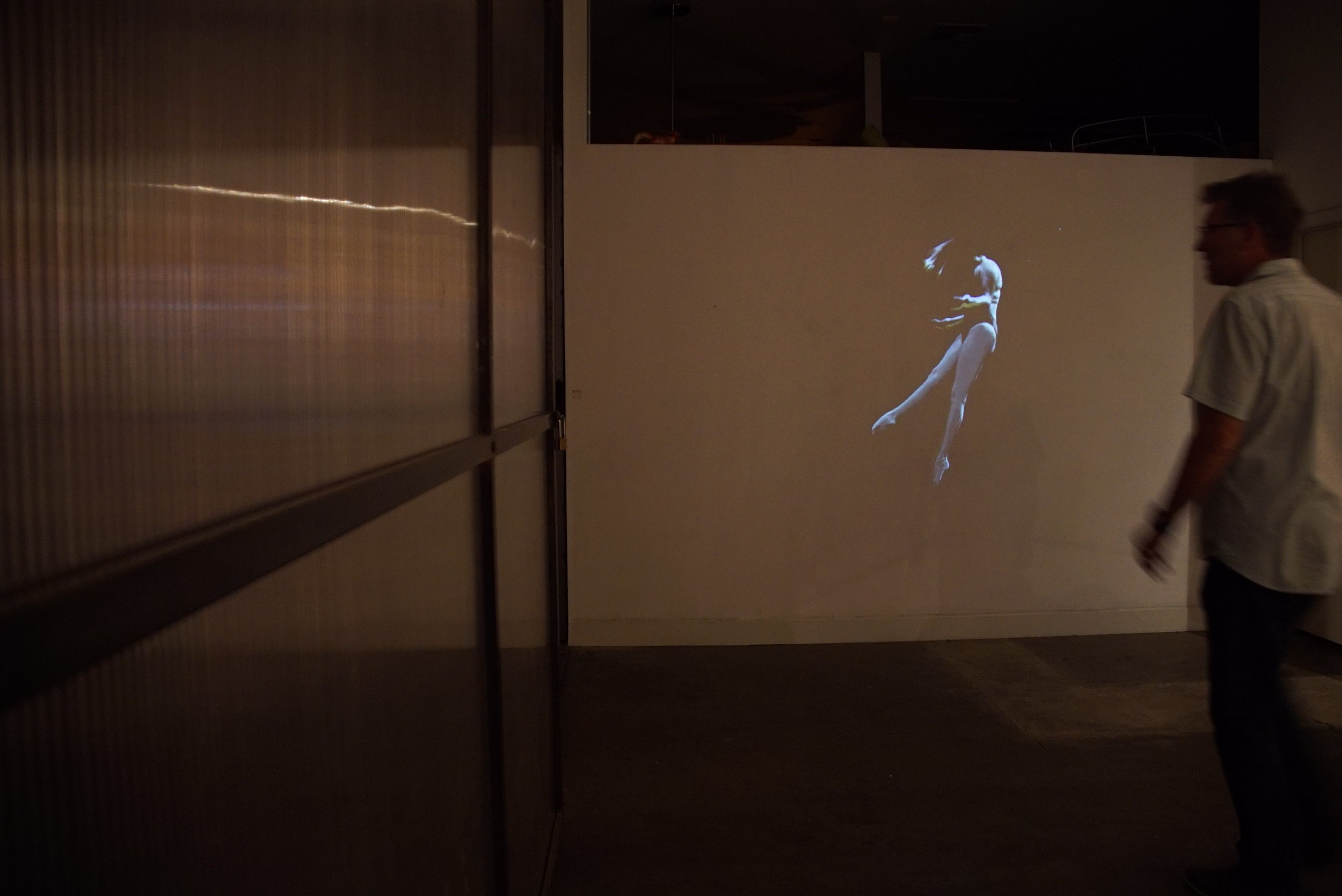 Underwater figure suspended in water from Groundwater, an immersive video projection installation by Kendra Sollars.