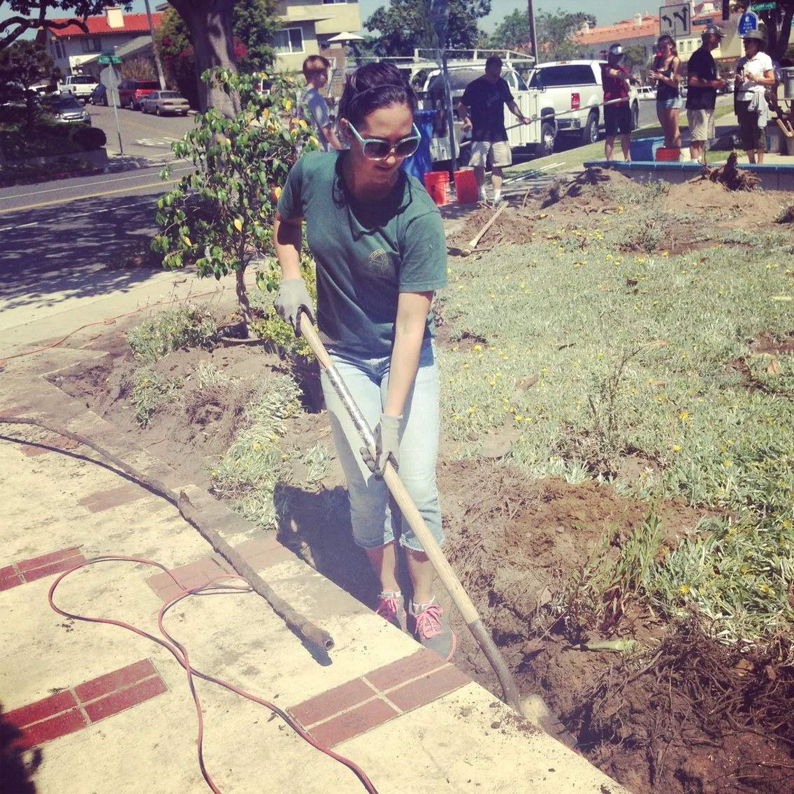 Rachael Cortez digging trenches for the brand new sprinkler system. Photo by Taylor Lewis