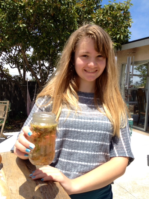 Ella preparing her facial tonic with fresh pick herbs