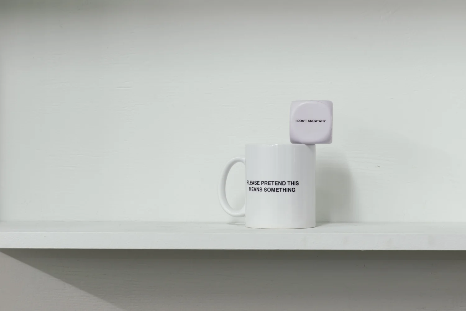 Louise Rutledge Please Pretend This Means Something 2014 Cermanic mug 12 x 9.5 x 8.2cm + I Don't Know Why 2014 Foam stress ball 4.8 x 4.8 x 4.8cm