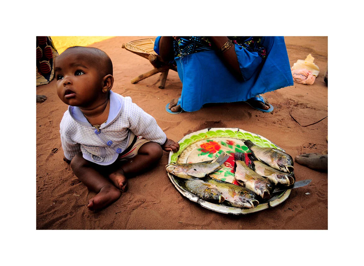 Fulani child with Tilapia. Near Chinko Nature Reserve, CAR