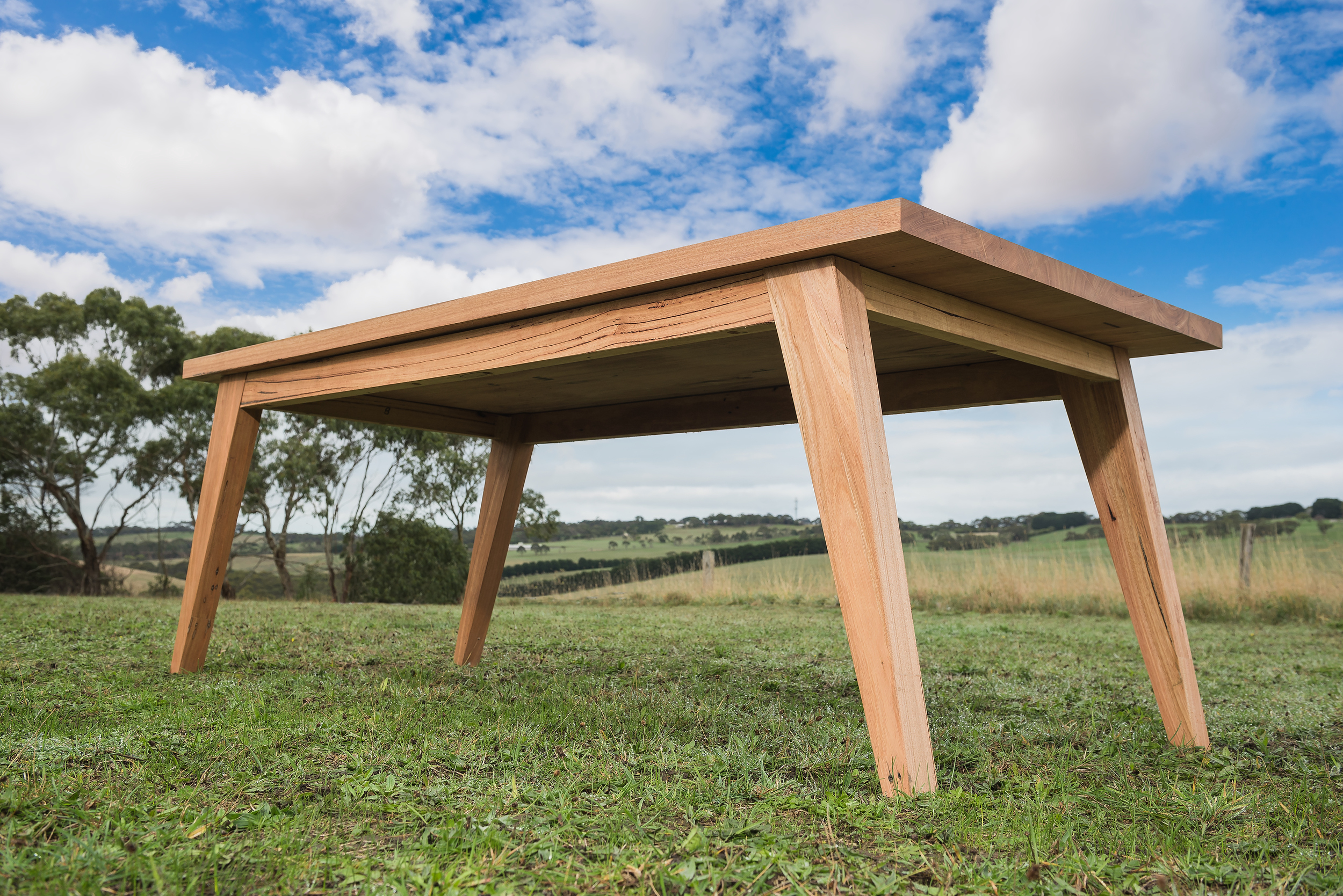 Angled leg solid timber table