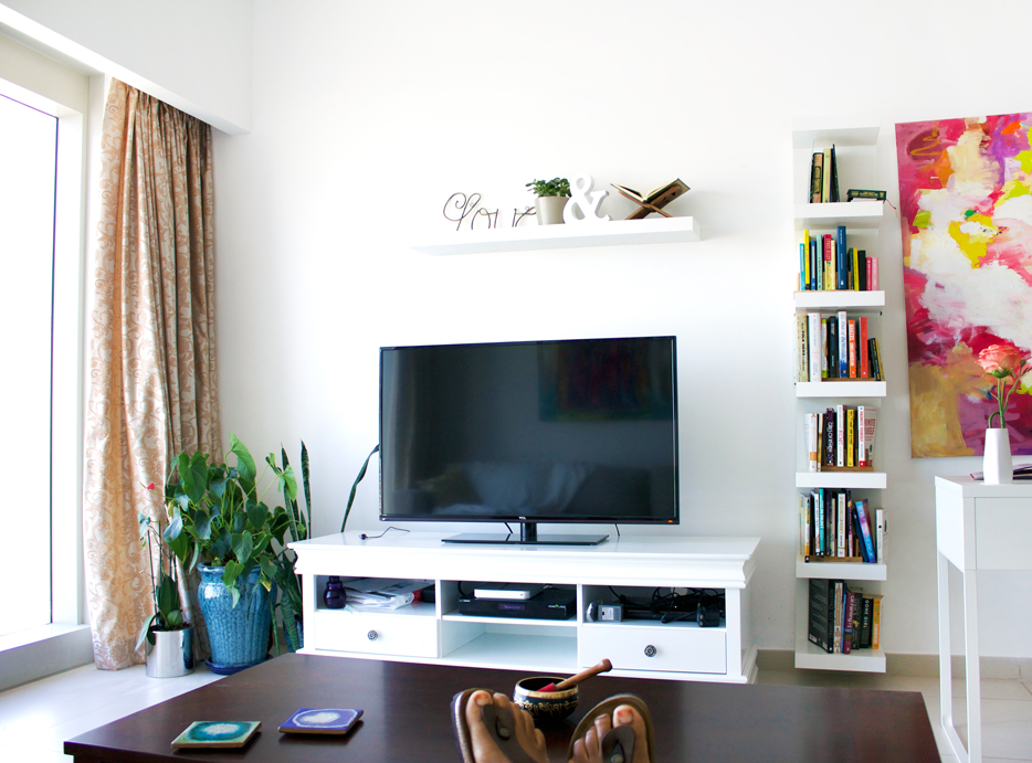 We simplified a lot in our living space. Cut out the big entertainment center for something more minimal and reflective of my personal style. (Trying to break in a new pair of Birks as well at home unsuccessfully)