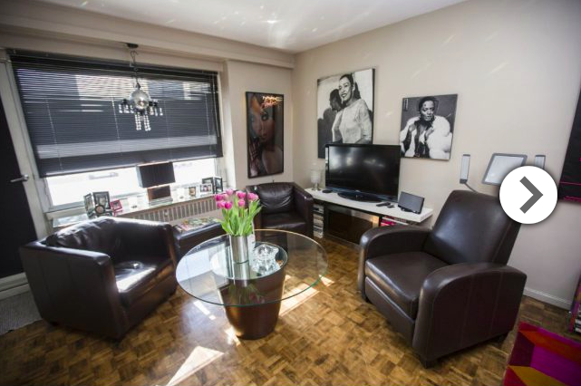 Club chairs make a comfortable corner of the living room, highlighted by one of Dilio’s disco balls. 