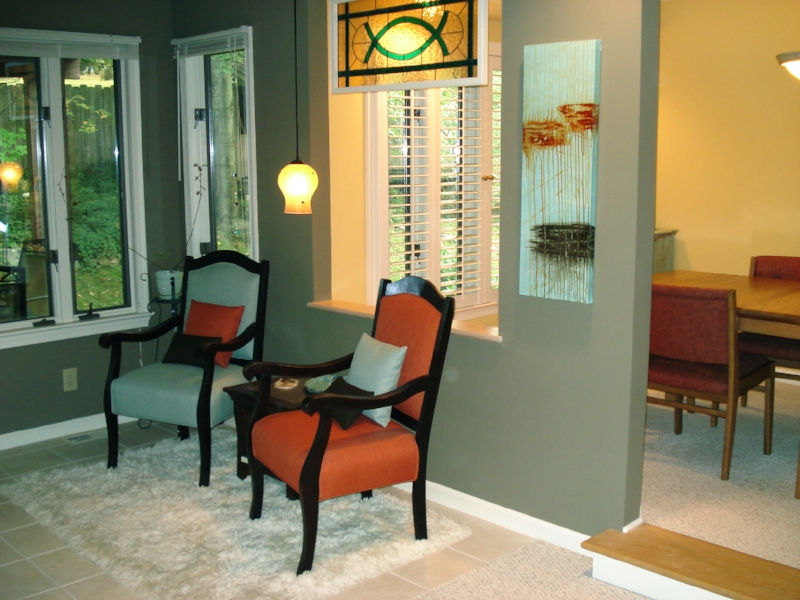 Shown hanging in a sitting area with chairs and pillows selected to match the colors of the painting.