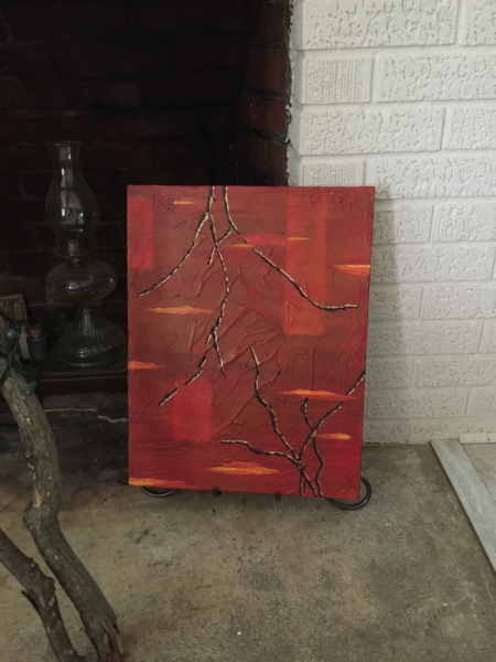 Shown on a small easel by a fireplace.