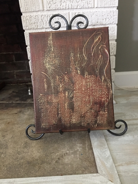 Shown on a table easel sitting beside a fireplace.