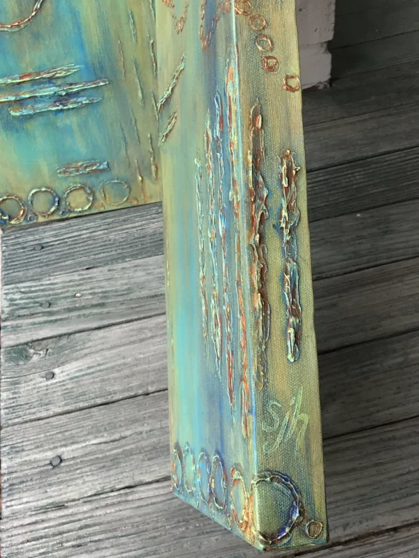 Detail photo of signature on side of canvas.