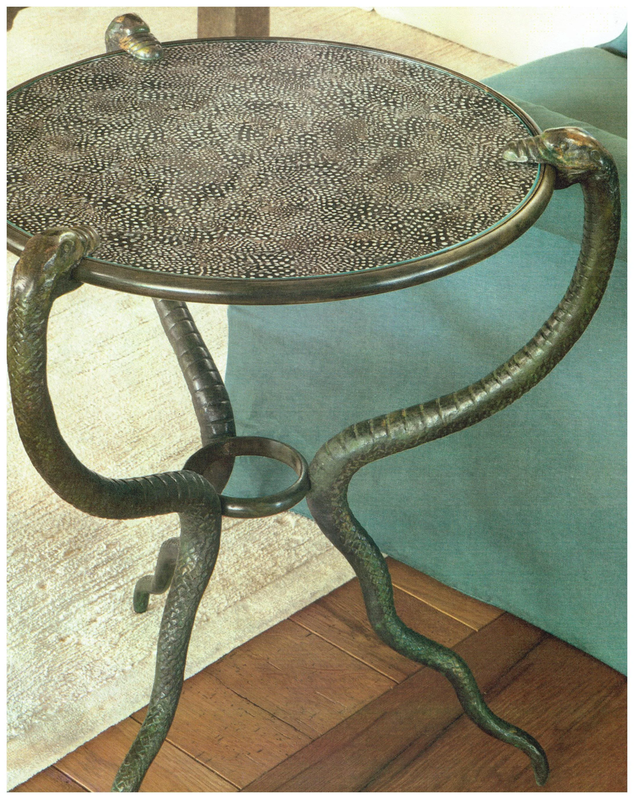 Rose Tarlow snake side table with guinea fowl feathers under glass top.