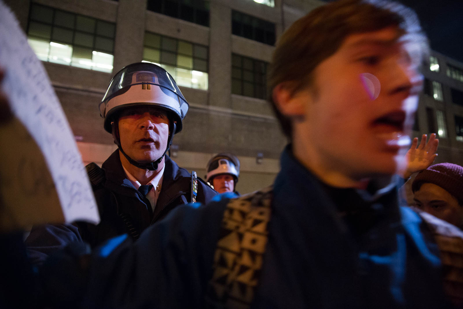 A police officer pushes protestors out of the street on the West Side Highway.