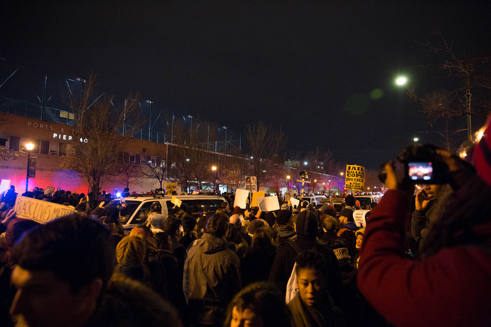 A crowd amasses on the West Side Highway, blocking traffic. 