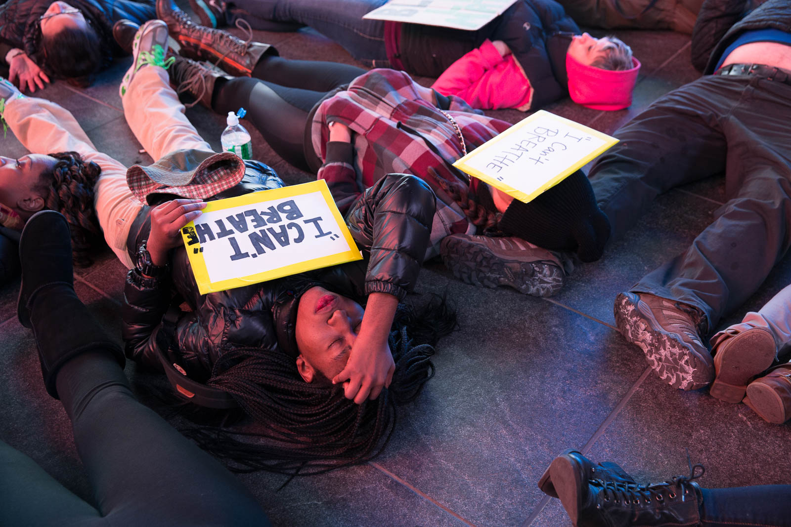 A woman lies down on the ground for a mass "die-in" in Times Square.