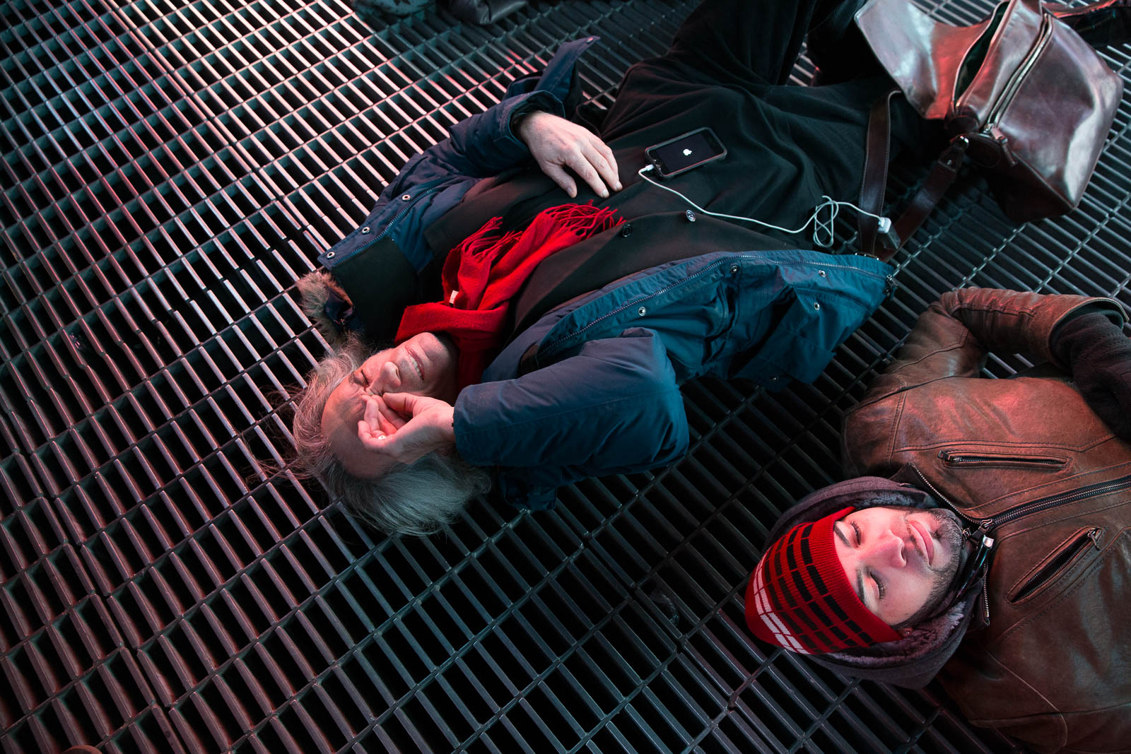 A man covers his face during a moment of silence at a mass "die-in" in Times Square.