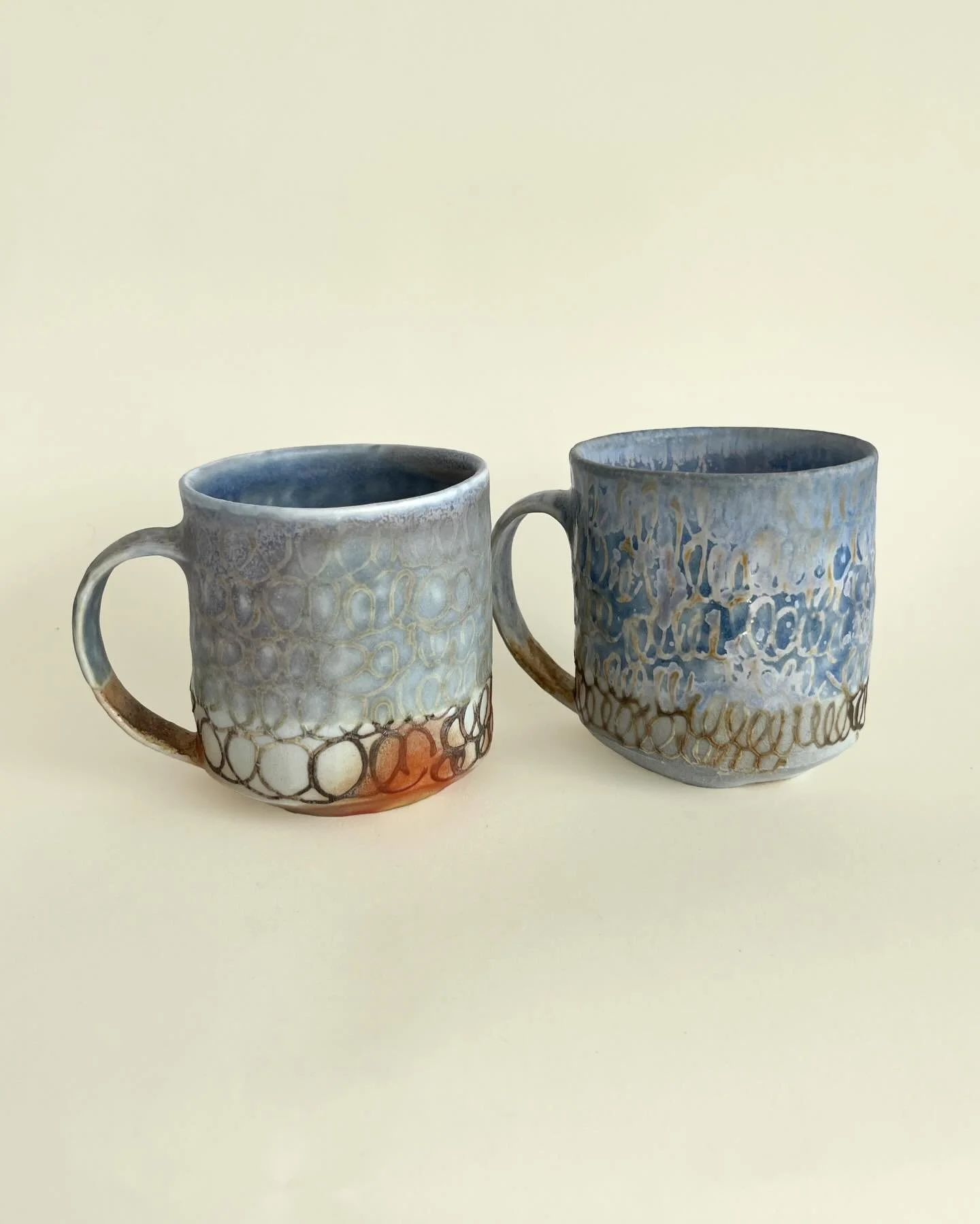 Wood fired cups from @theokidokistudio. I had the bright idea to bring my squeezey bottles upstate to do some designs with the shinos and celadon they have there and was really pleased with how these came out