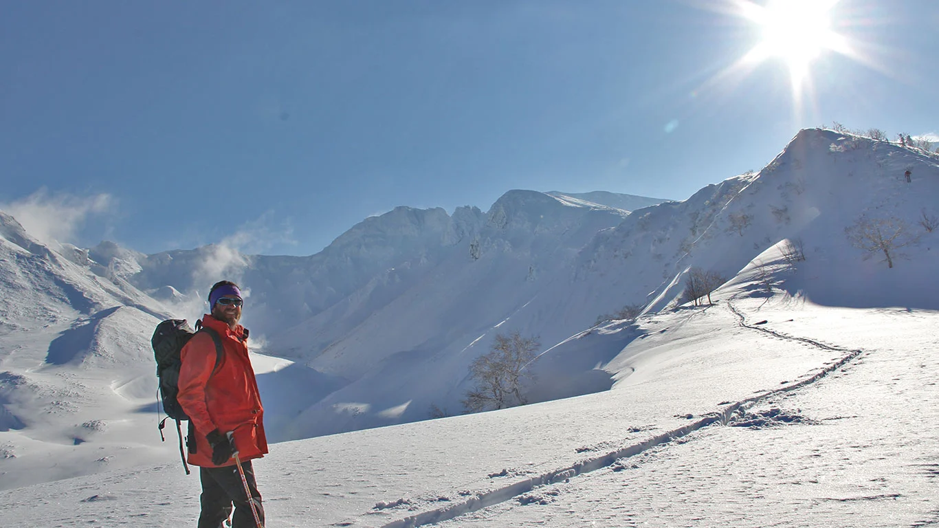 Tokachi Mts. Climbing the "D Ridge" on skins, looking for first tracks on a bluebird day.