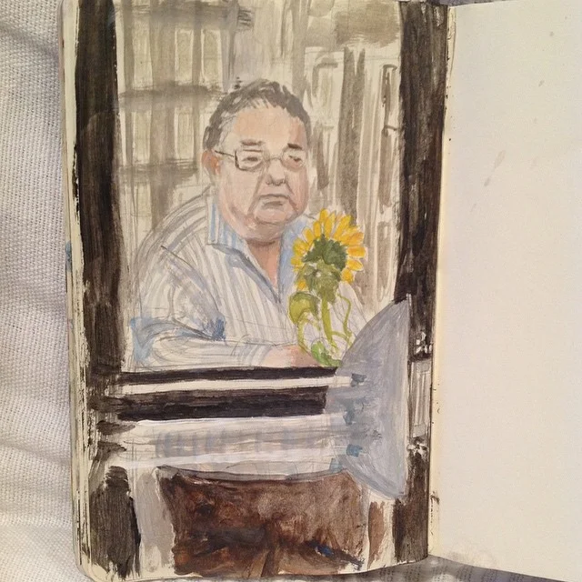 This man looking out a window with his sunflower looked so sad....