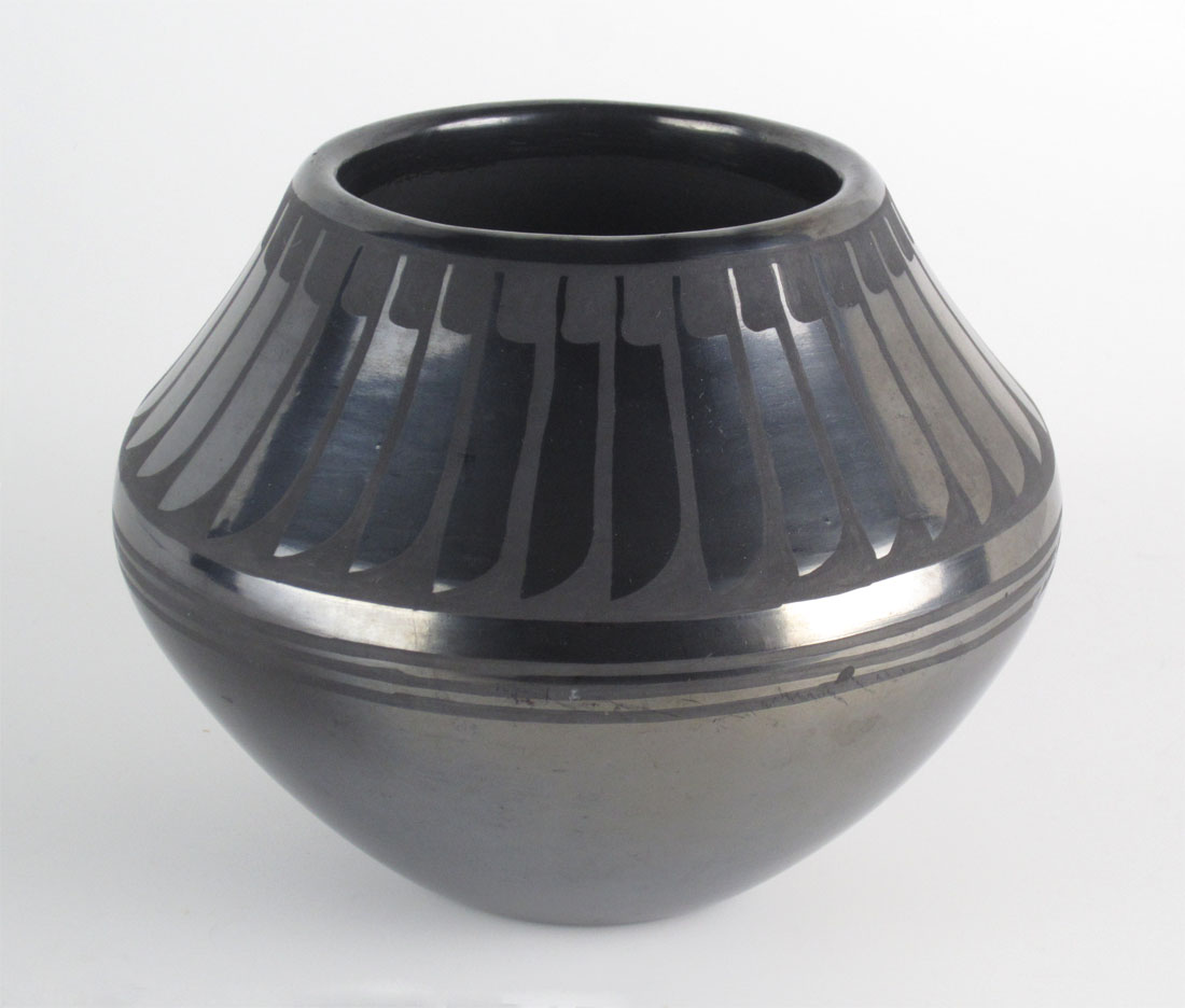 Gunmetal black on black jar signed Maria + Santana http://www.marcyburns.com/pottery-collection/san-ildefonso-gunmetal-jar-by-maria-and-santana