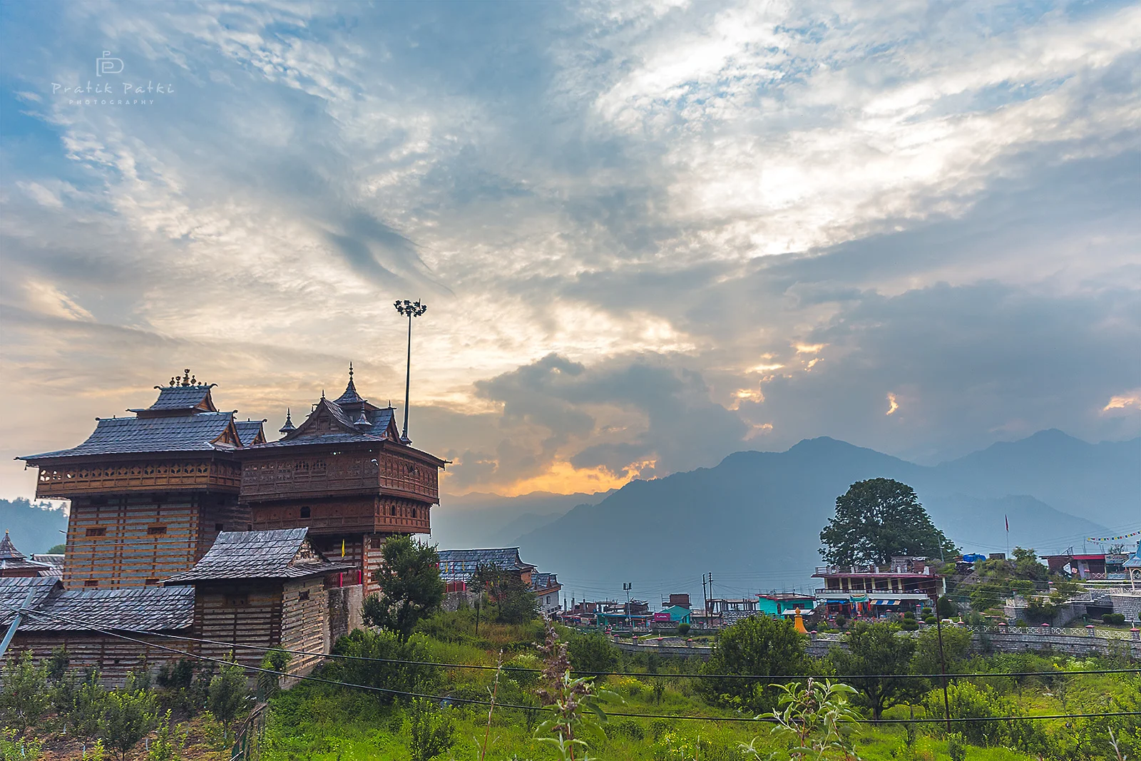 A beautiful evening comes to an end. The temple stands tall amidst the smaller houses and the sunset sky