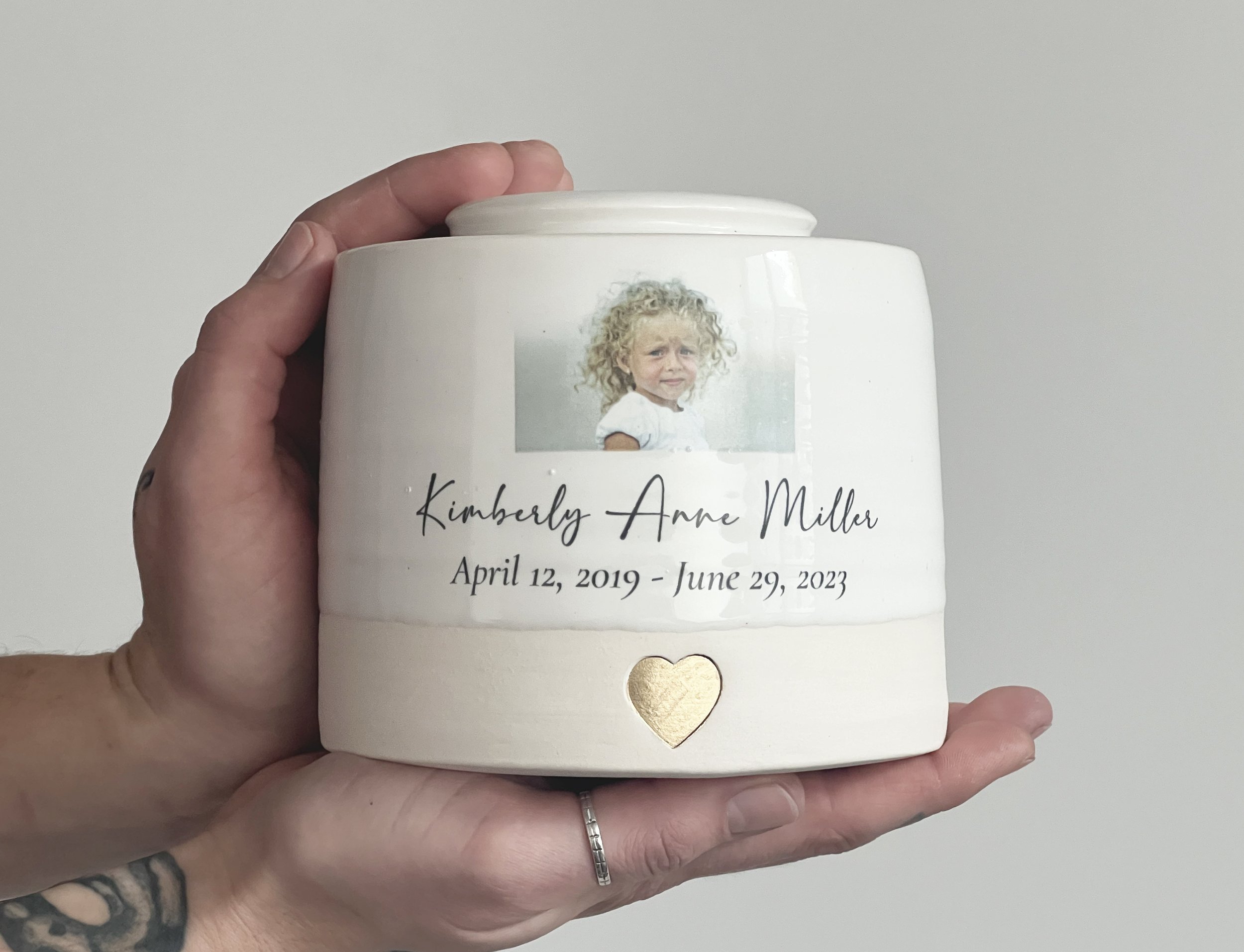 medium infant urn in hand.jpg