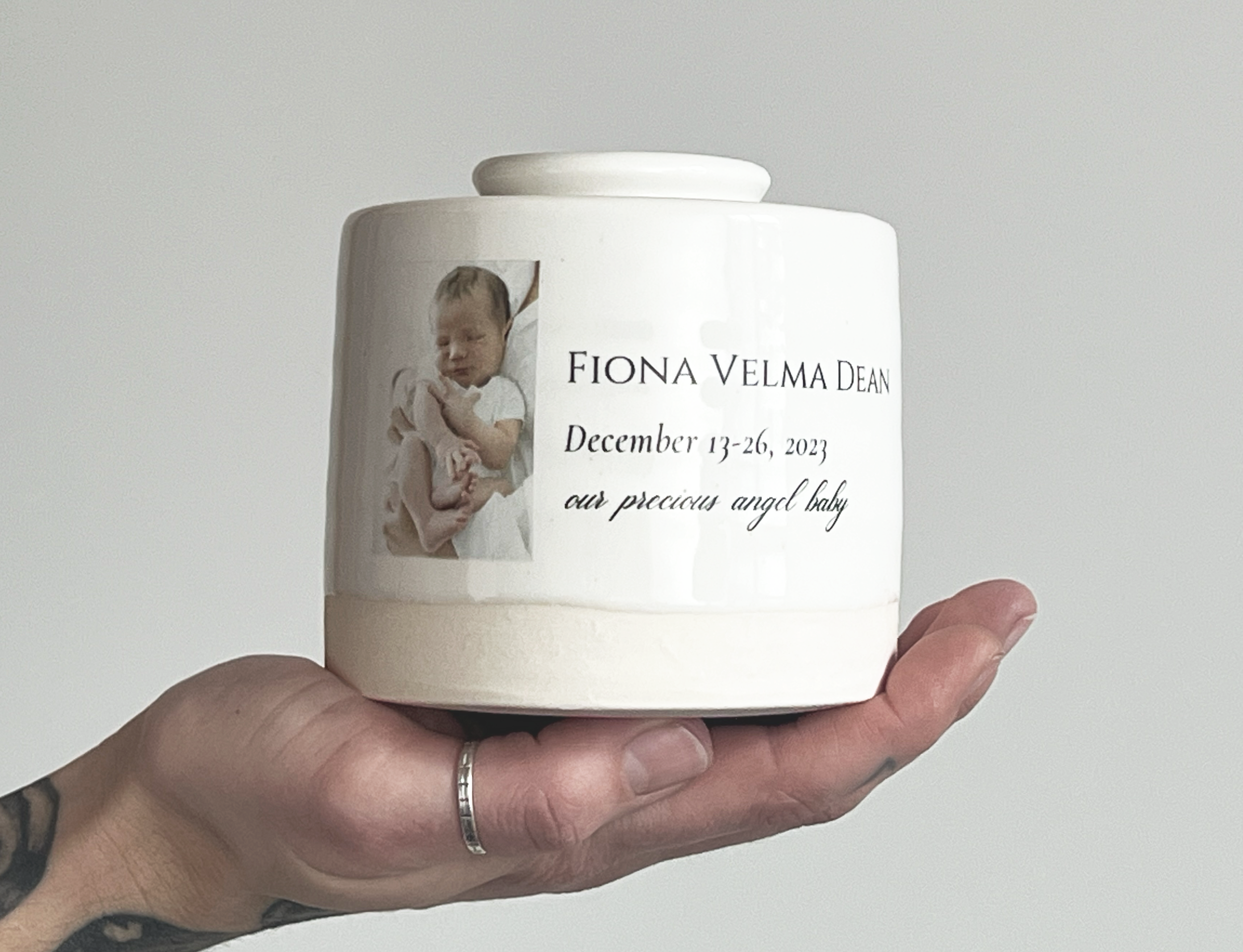 small infant urn in hand 2.png