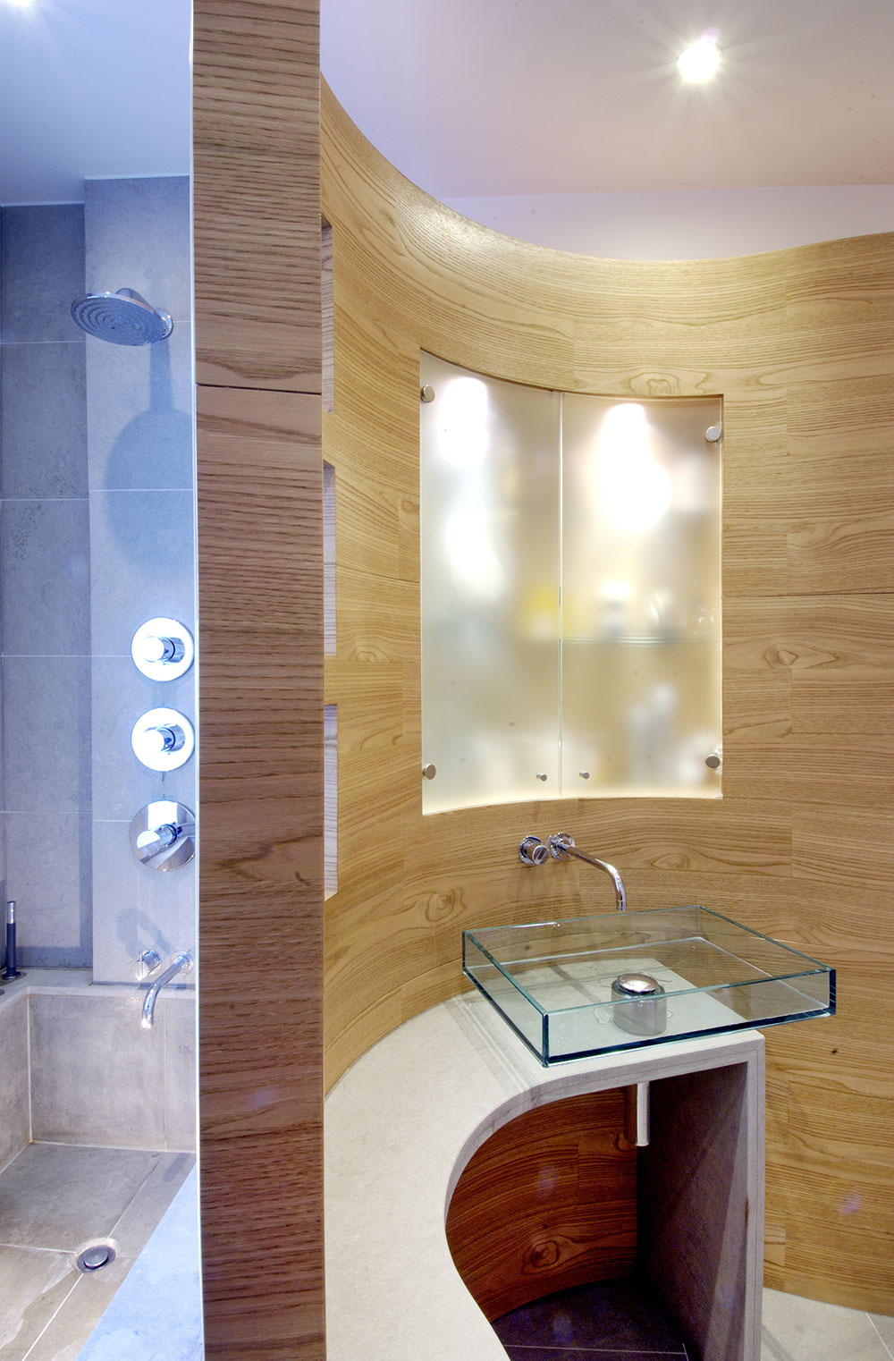 This veneered bathroom conceal shows wood panelling working beautifully in a modern interior.