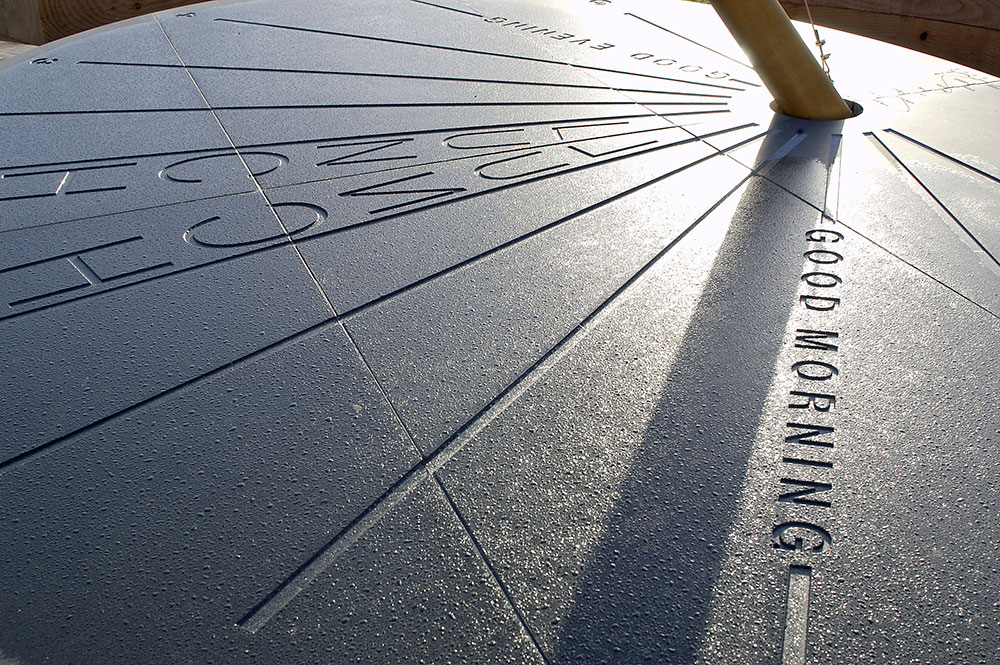 A giant Kirkstone slate Sundial Picnic Bench is the last of three arty concept pieces we designed and built for TTP at Melbourn Science Park. The sundial's six-metre high spruce gnomon was installed with guidance from a passing scientist who helped us align it accurately with true north. The heavy baulks, or benches, made from solid douglas fir seat up to 24.