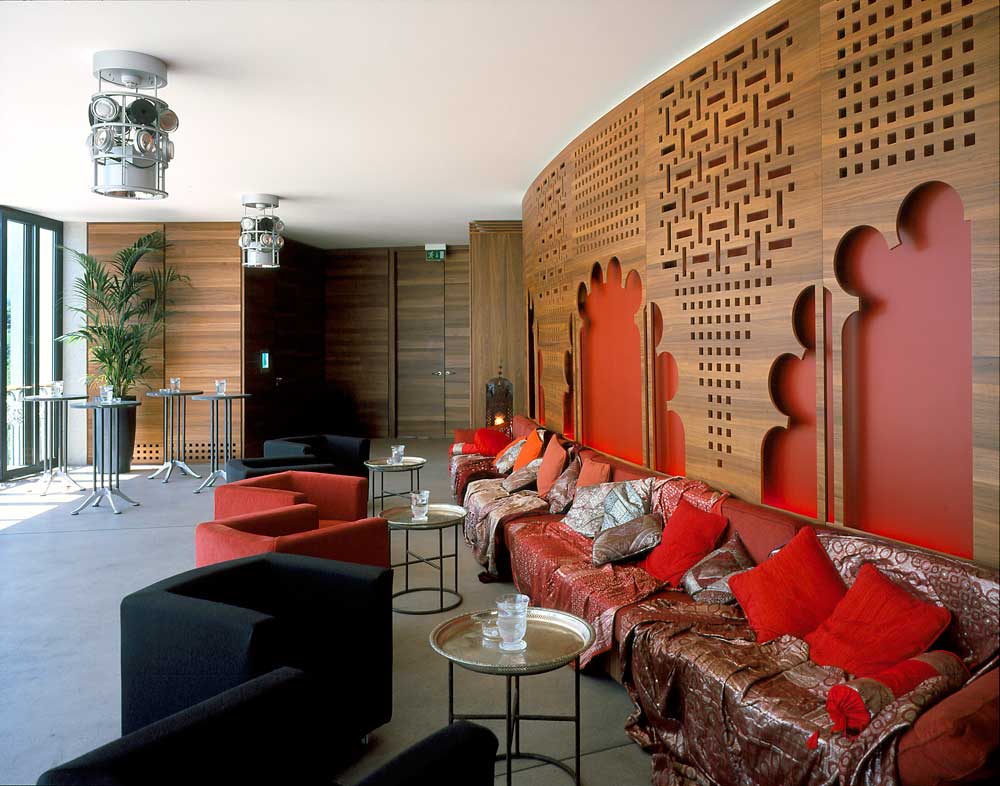 The geometric design of the laser cut wood panelling in the lounge bar is an exact replica in walnut of a key theatrical set from the Ludvig II opera.