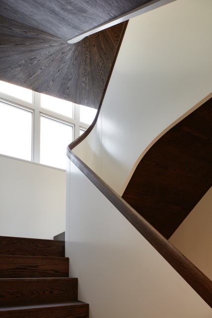 We designed this staircase together with Architect Robert Hirschfield . The elegant lacquered balustrade is capped with a continuous moulded handrail, hand carved from oak to match the fluid underside that follows the curves of the staircase. It all came out with the feel of an Edwardian Gentlemen's yacht; lovely, if we do say so ourselves.