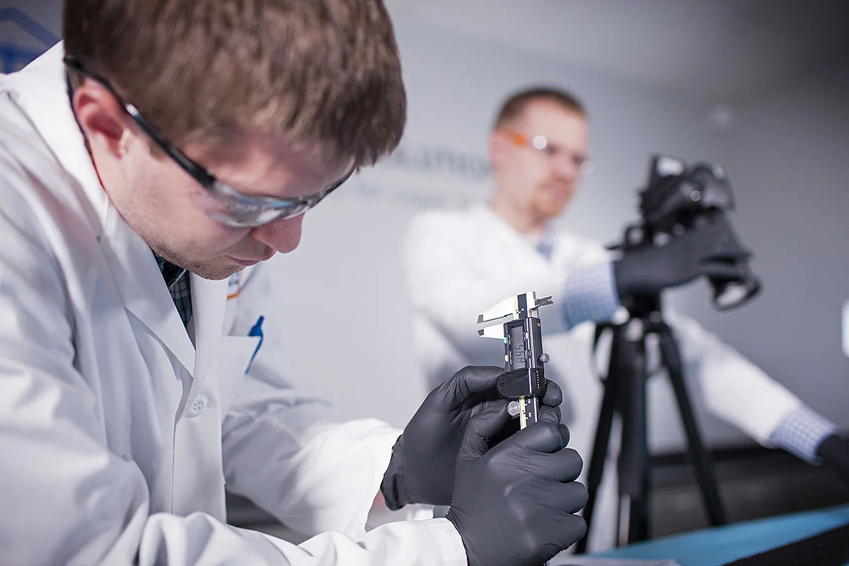 Scientists using instruments in a lab.