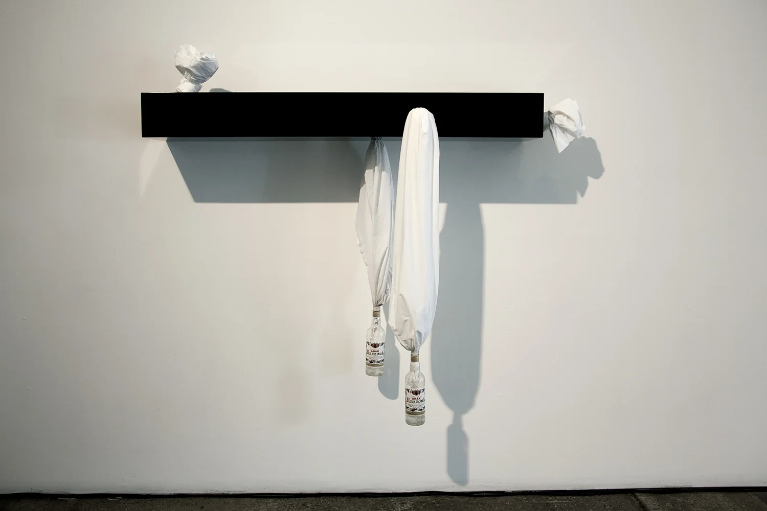 Sweat (3) , 2014, Two bed sheets, two filled Arak liquor bottles, shelf, 59”W x 6.5”D x 24”H