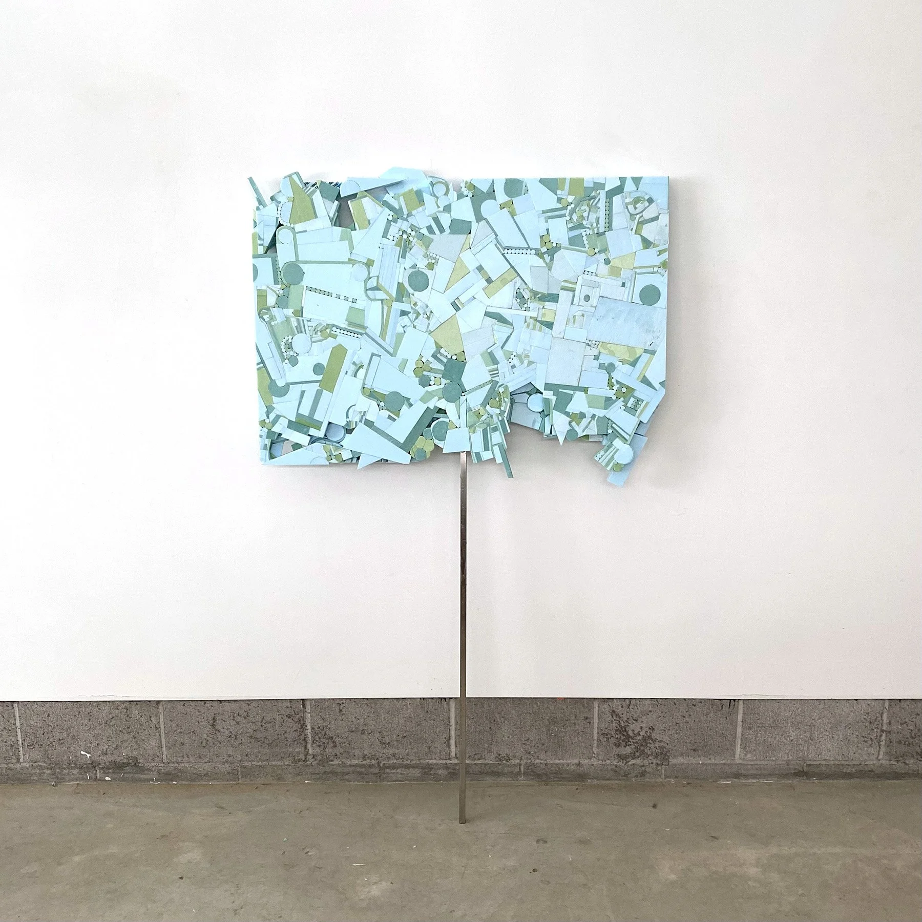  Protest Quilt  (a patchwork of small grievances organized as a green screen collage in the form of a protest sign)  polystyrene, hot glue and stainless steel  66 × 40 × 2”  2025 